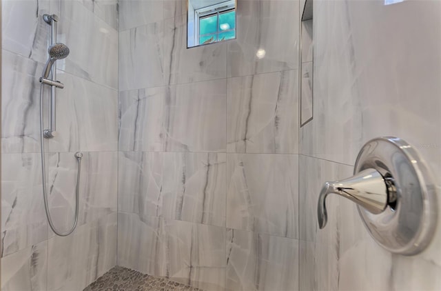 bathroom with a tile shower