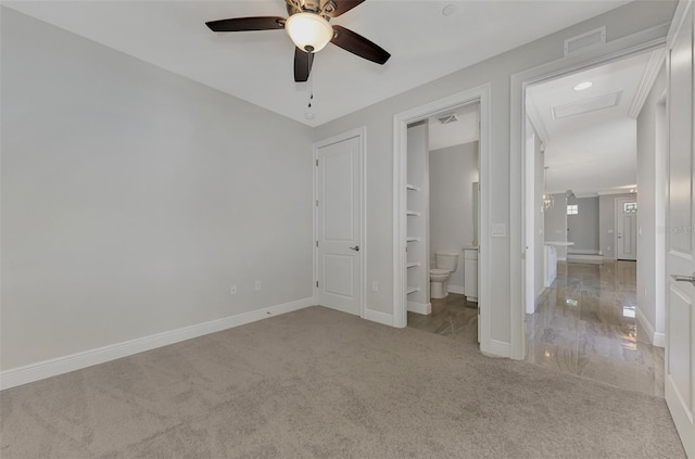 unfurnished bedroom with ceiling fan, carpet, and ensuite bathroom