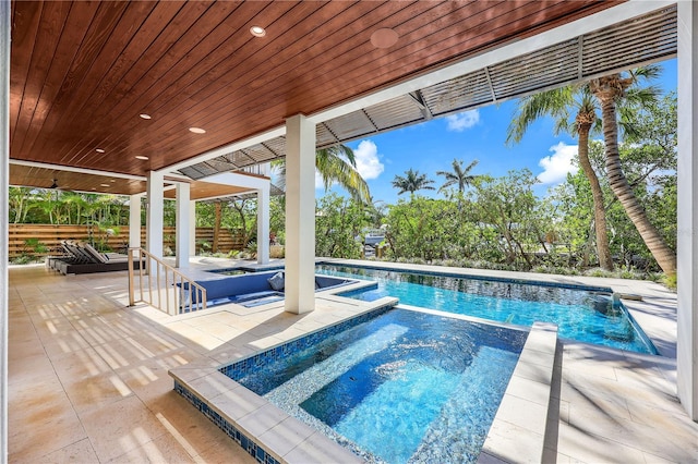 view of pool featuring an in ground hot tub and a patio