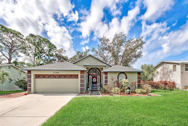 ranch-style home with a garage and a front lawn