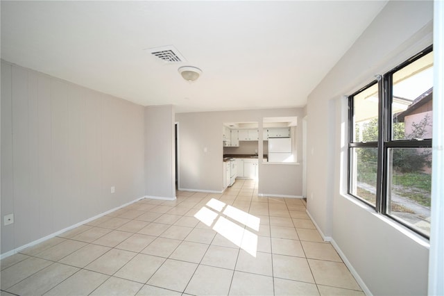 unfurnished living room featuring light tile patterned floors