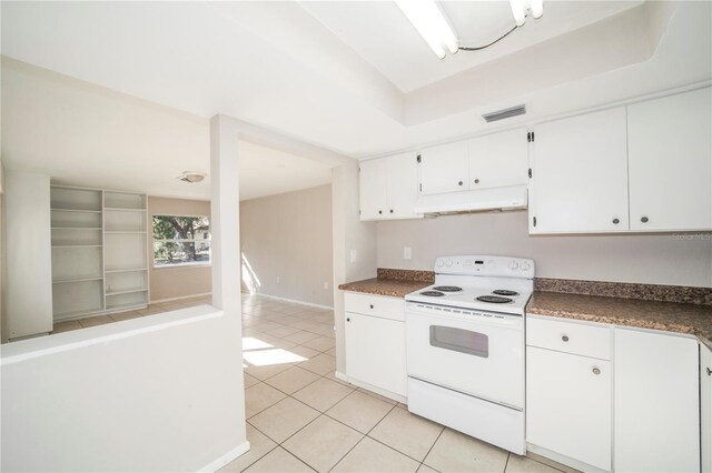 kitchen with electric stove, white cabinetry, and light tile patterned flooring