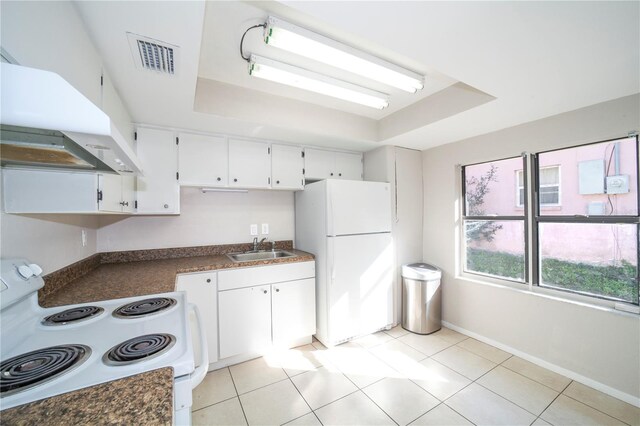 kitchen with white cabinetry, white appliances, sink, a raised ceiling, and extractor fan