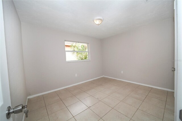 spare room featuring light tile patterned floors