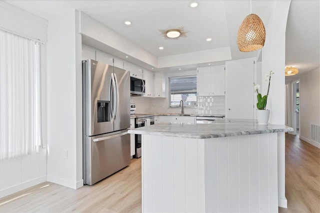 kitchen featuring light wood-type flooring, sink, stainless steel appliances, and white cabinets