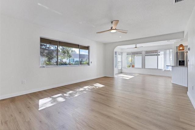 unfurnished living room with light hardwood / wood-style flooring and ceiling fan