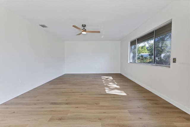 unfurnished room with light wood-type flooring and ceiling fan