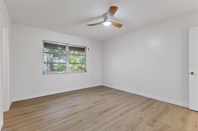 empty room with ceiling fan and light hardwood / wood-style floors