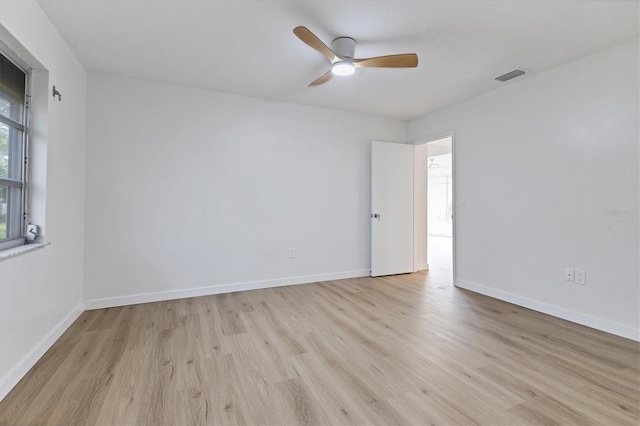 spare room featuring light wood-type flooring and ceiling fan