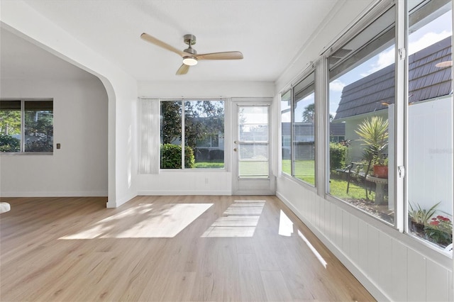 unfurnished sunroom featuring ceiling fan