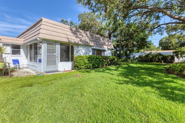 rear view of house with a lawn