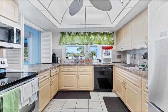 kitchen featuring backsplash, light tile patterned floors, stainless steel appliances, sink, and ceiling fan