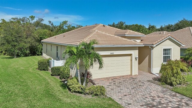 ranch-style home with a front yard and a garage