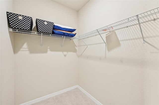 walk in closet with tile patterned floors