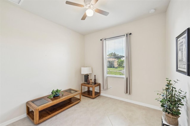 sitting room with light tile patterned floors, ceiling fan, and baseboards