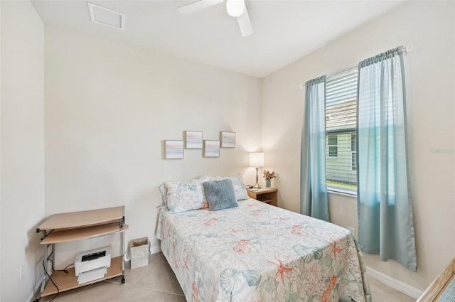 bedroom featuring baseboards, tile patterned flooring, visible vents, and a ceiling fan