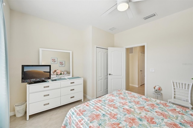 bedroom with light tile patterned floors, a closet, visible vents, a ceiling fan, and baseboards