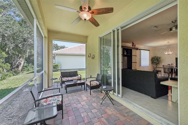 sunroom / solarium with ceiling fan with notable chandelier