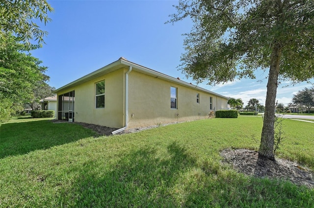 view of home's exterior featuring a lawn and stucco siding