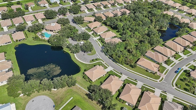 birds eye view of property with a water view and a residential view