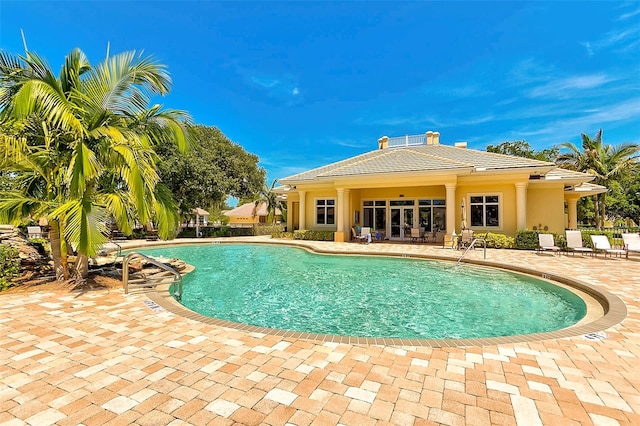 pool featuring a patio and fence