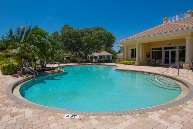 pool featuring french doors and a patio area