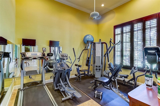 gym featuring baseboards, crown molding, and recessed lighting