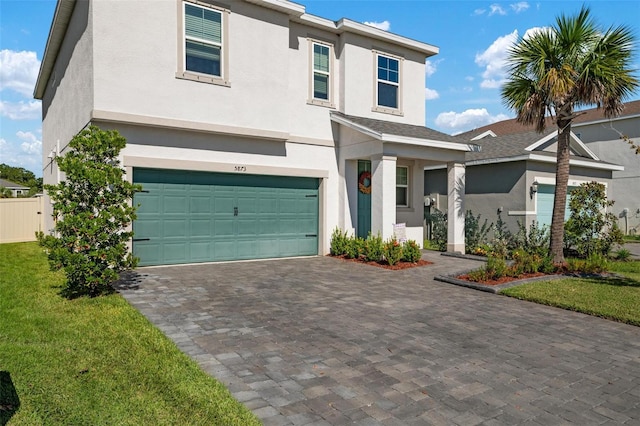 view of front of home featuring a garage and a front lawn