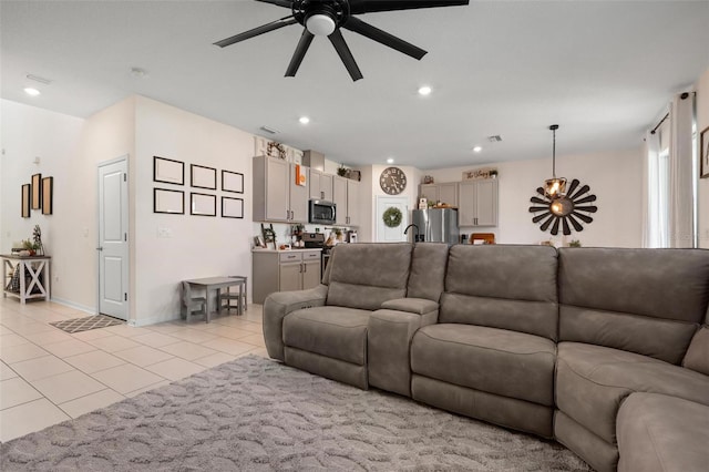 living room featuring ceiling fan and light tile patterned floors