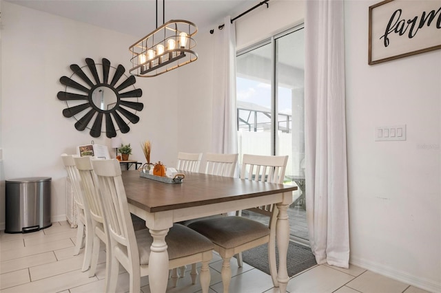 dining room with a notable chandelier and light tile patterned floors