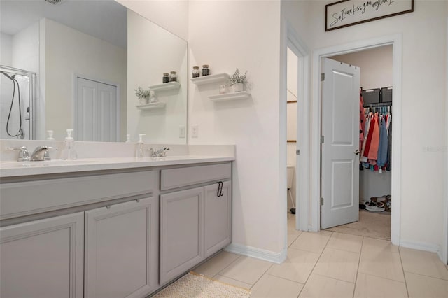 bathroom featuring tile patterned floors, vanity, and an enclosed shower