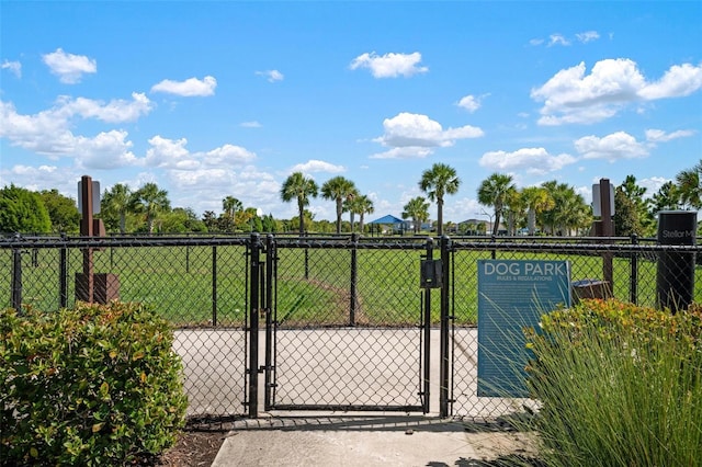 view of gate featuring a yard