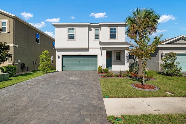 front facade featuring a front lawn and a garage