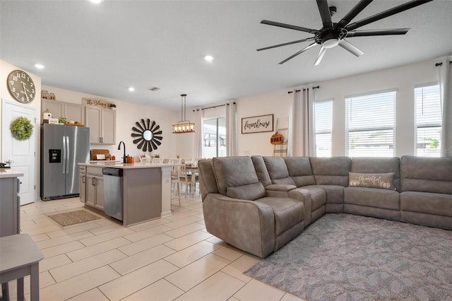 living room featuring ceiling fan and sink