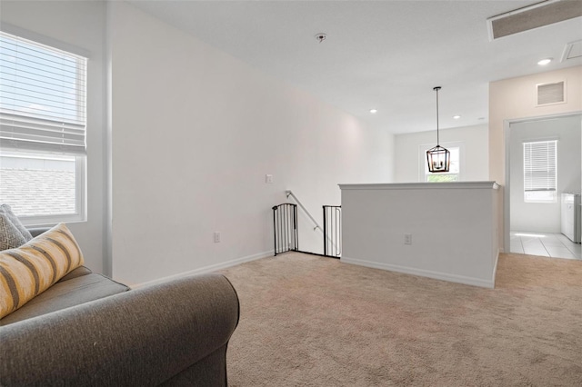 living area with light carpet and a healthy amount of sunlight