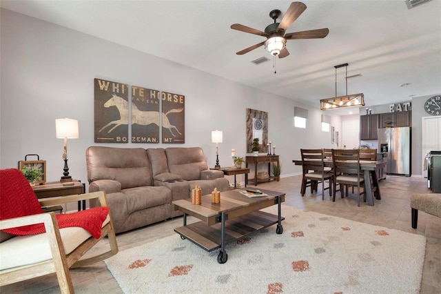 tiled living room featuring ceiling fan