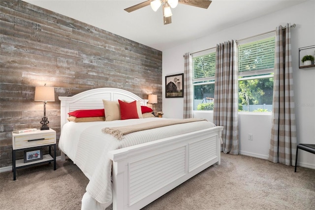 carpeted bedroom featuring multiple windows and ceiling fan