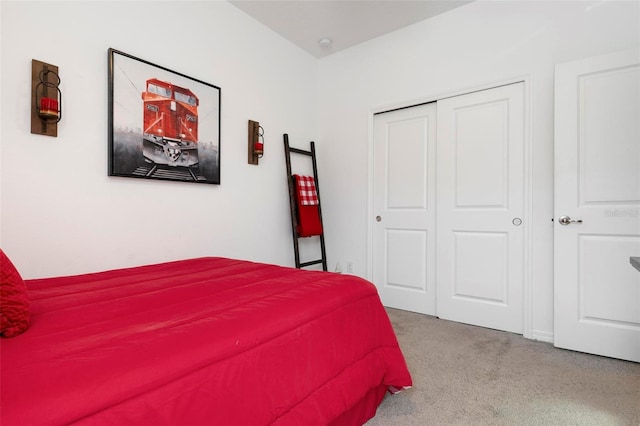 bedroom featuring a closet and light colored carpet