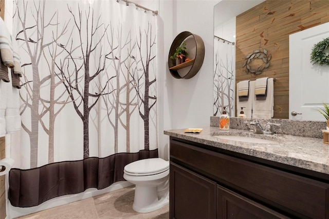 bathroom featuring vanity, toilet, and a shower with shower curtain