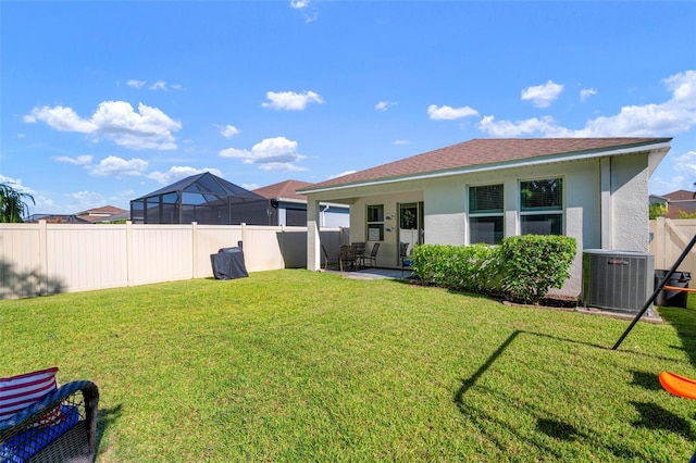 exterior space featuring cooling unit, a lawn, and a patio