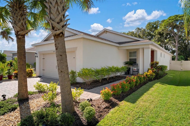 view of front of home with a garage and a front yard