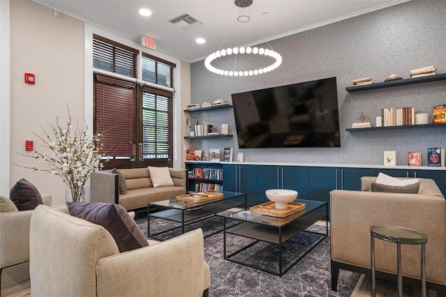 living room featuring a notable chandelier and crown molding