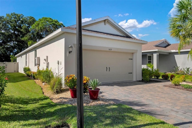 view of property exterior featuring a lawn and a garage