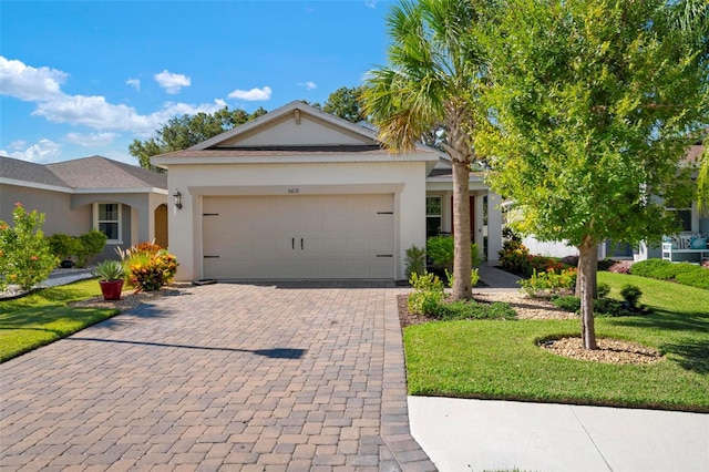 view of front of home featuring a garage and a front lawn