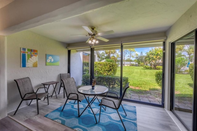 sunroom / solarium featuring ceiling fan