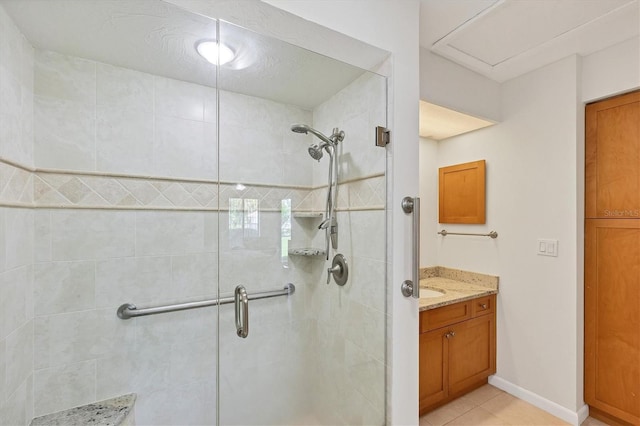 bathroom featuring tile patterned flooring, vanity, a shower with shower door, and a textured ceiling