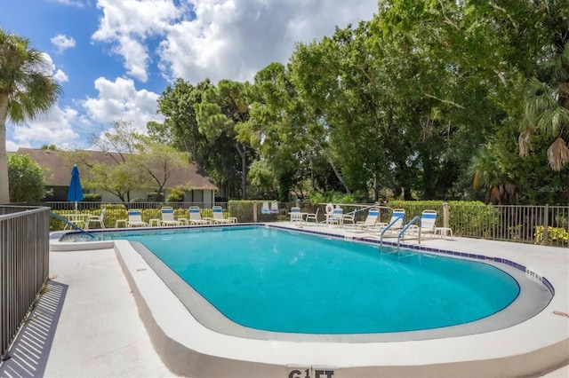 pool featuring a patio area and fence