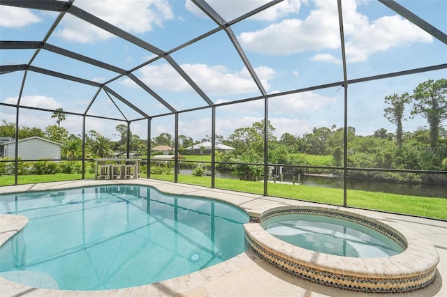 view of pool featuring a lawn, glass enclosure, an in ground hot tub, and a patio