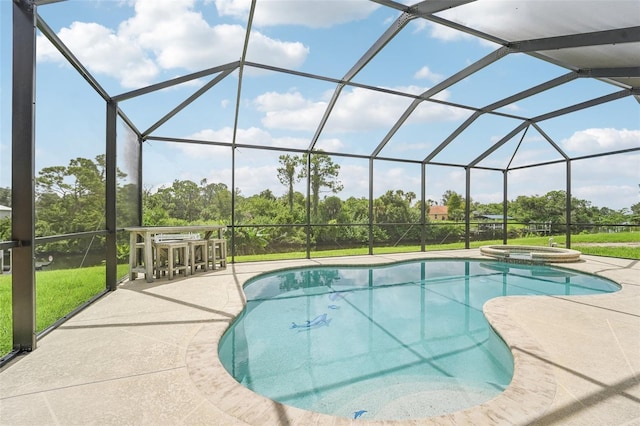 view of swimming pool with glass enclosure, a patio area, and an in ground hot tub