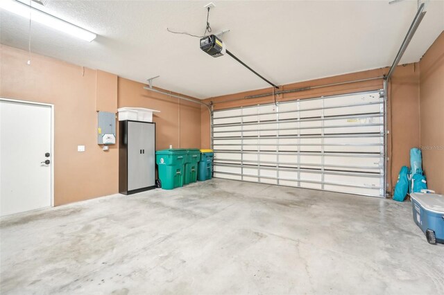 garage with electric panel and a garage door opener